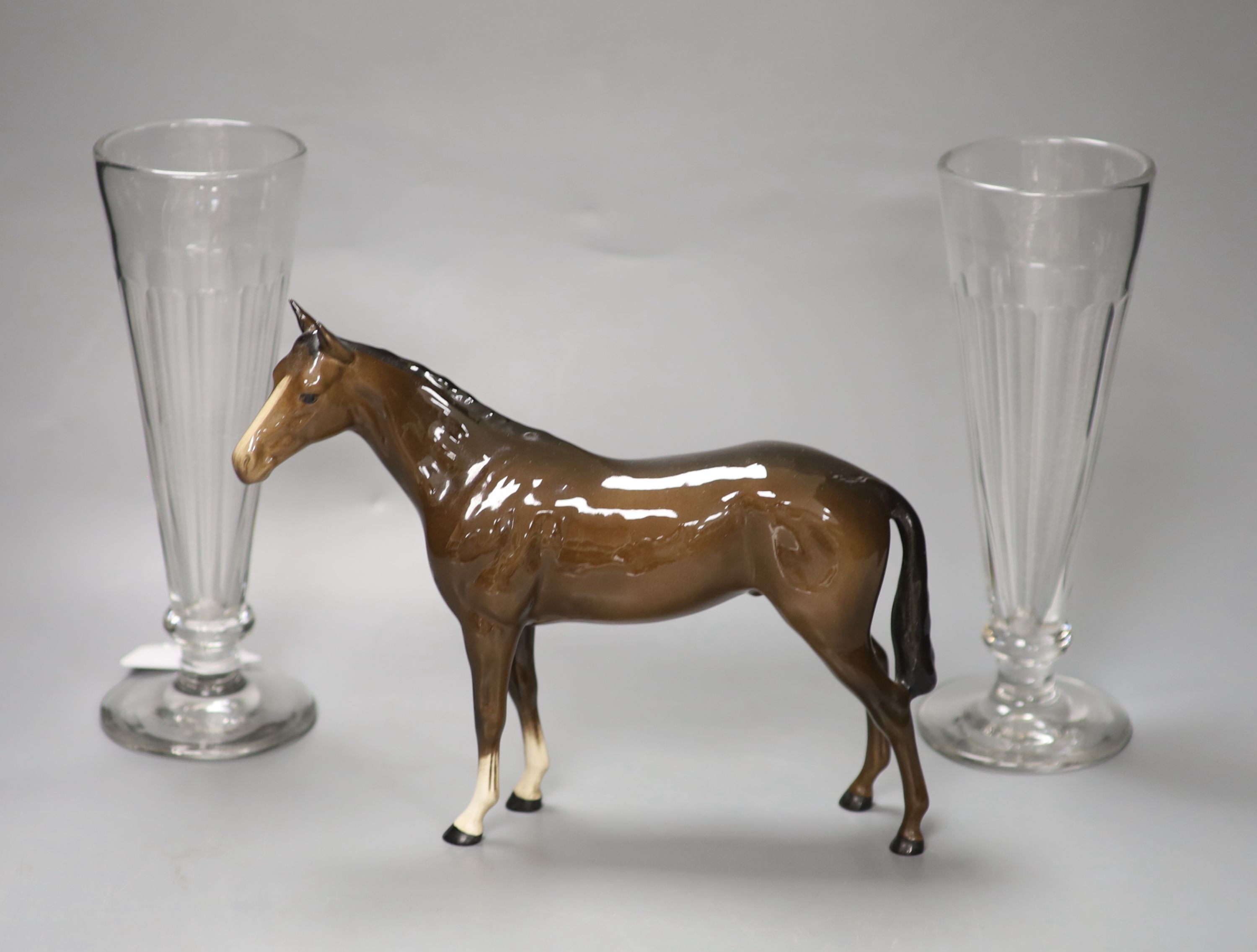 A pair of panel-cut ale flutes, 24cm high and a Beswick bay stallion